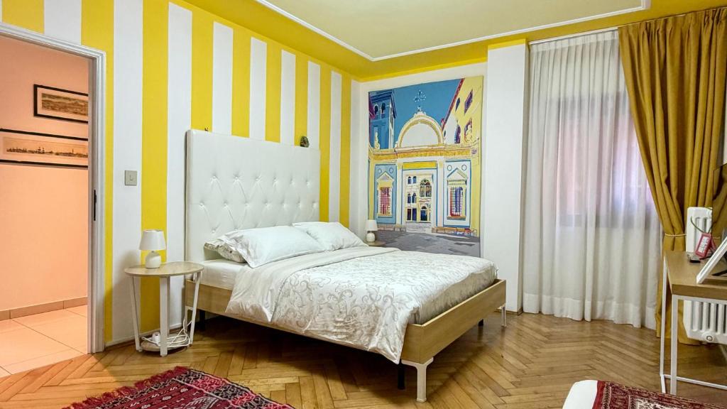 a bedroom with a bed and a painting on the wall at Behind On The Canalside Venice in Venice