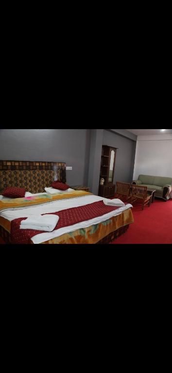 a bedroom with two beds and a red carpet at Hotel Sangla Retreat in Sāngla