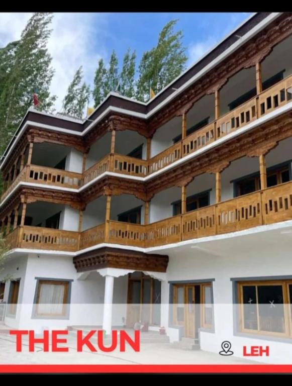 a building with wooden balconies on top of it at The Kun in Leh