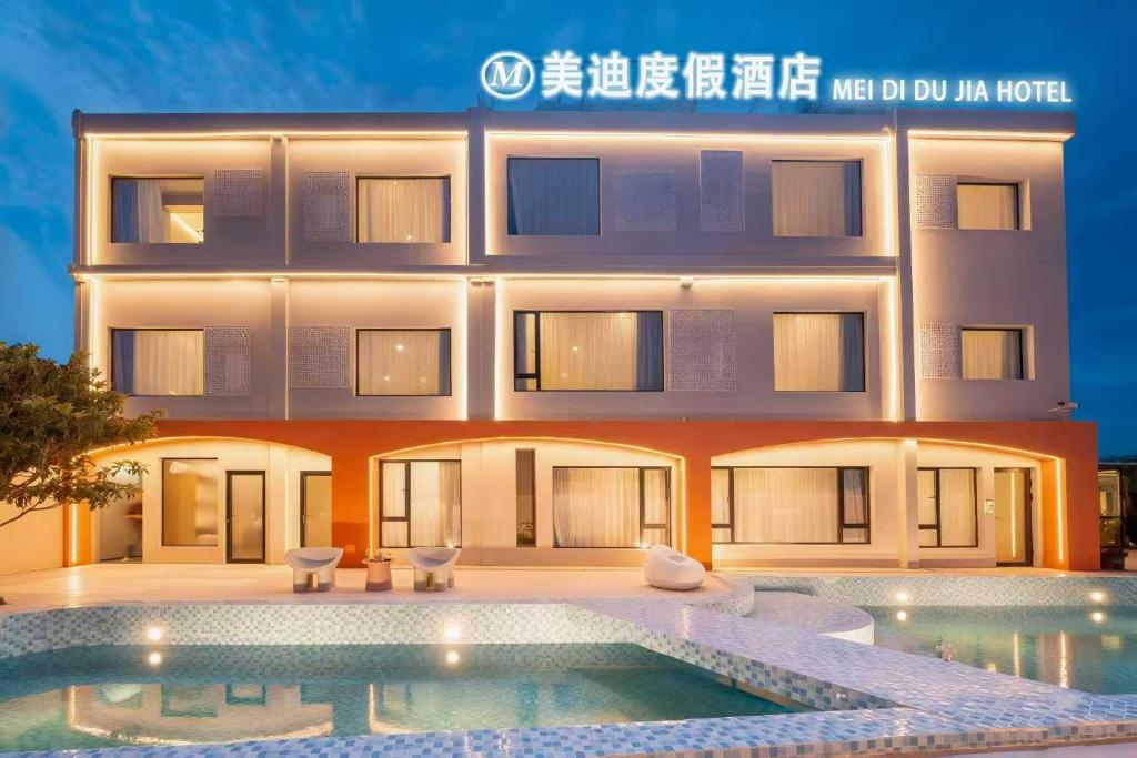 a hotel with a swimming pool in front of it at MEI DI DU JIA HOTEL in Shanghai