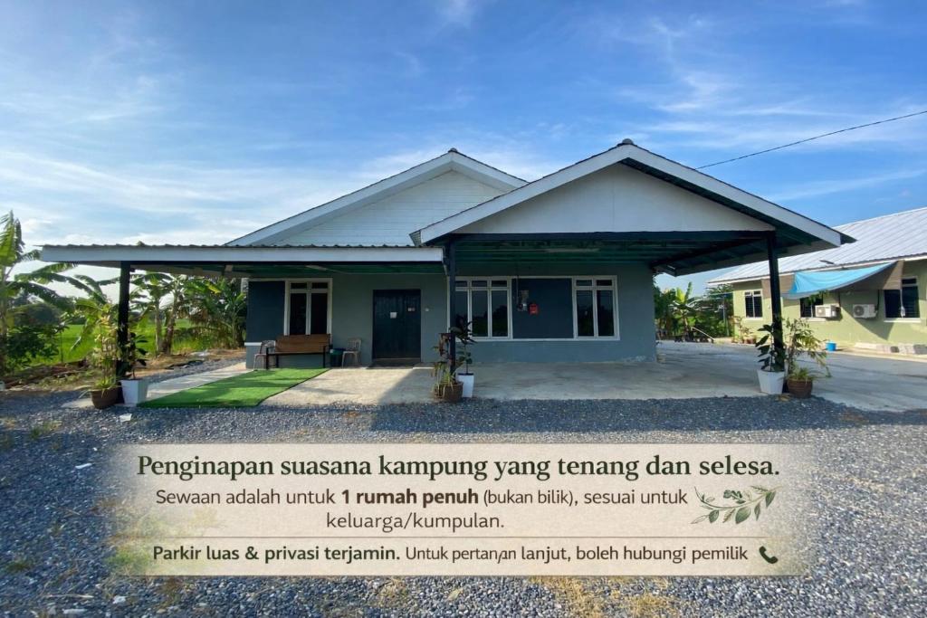 a house with a sign in front of it at Teratak D' Chemumaq Arau in Arau