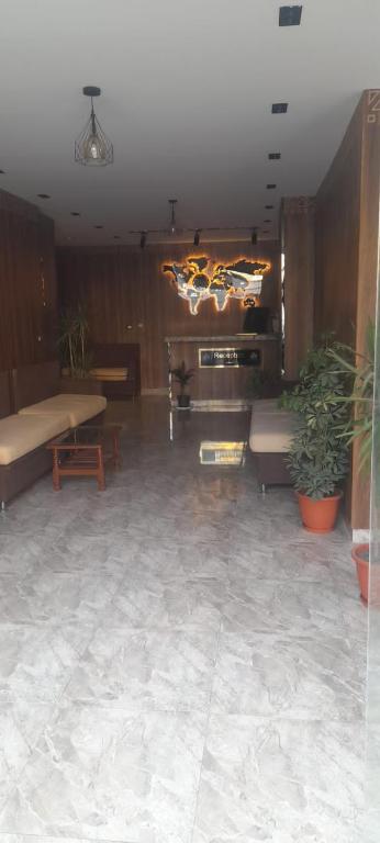 a living room with a couch and a piano at فندق النادي in Aswan