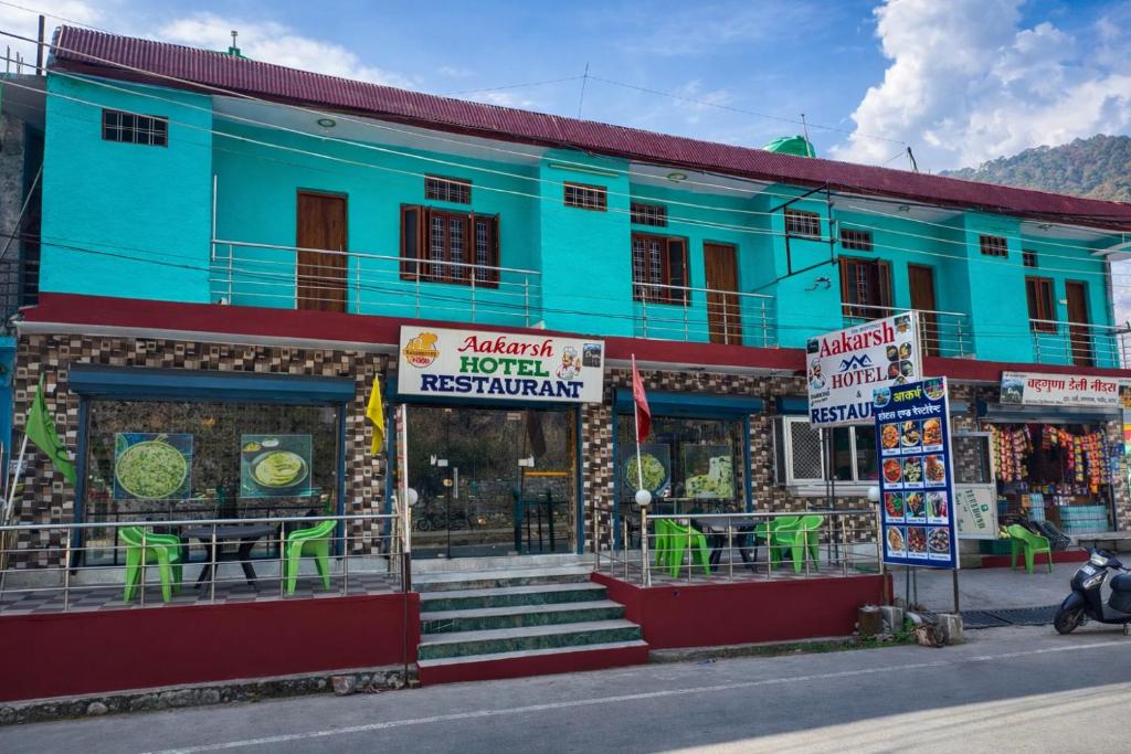a blue building on the side of a street at Aakarsh Hotel in Rudraprayāg