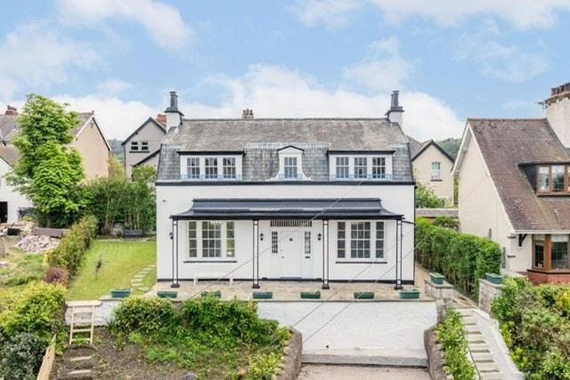 a large white house with a lot of windows at Luxury 6 bed house by the sea in Rhos-on-Sea