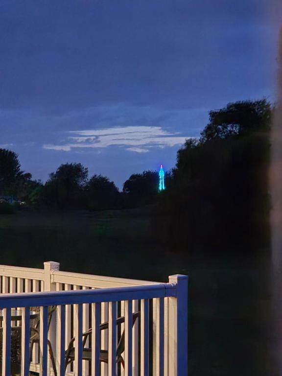 a blue light in the distance behind a fence at Tower View Retreat, Haven Marton Mere in Blackpool