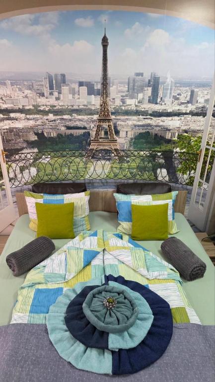 a large bed in front of the eiffel tower at Velvita Central in Sliven