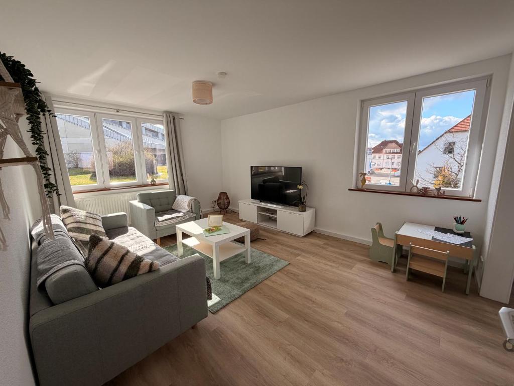 a living room with a couch and a tv at Cozy Home in Schramberg