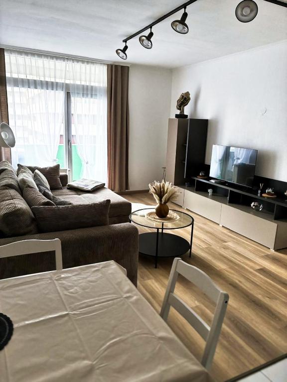 a living room with a couch and a tv at Burgberg-Oase in Bad Harzburg