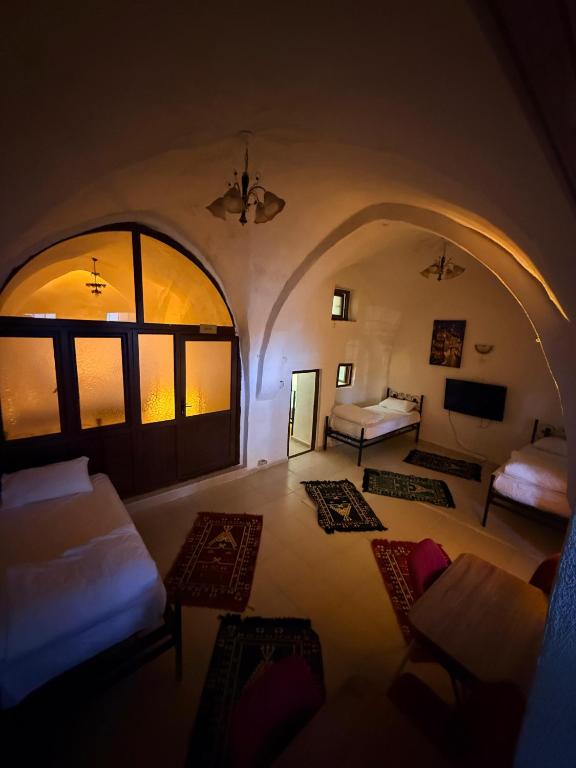 a room with a living room with a couch and tables at Ro House in Mardin