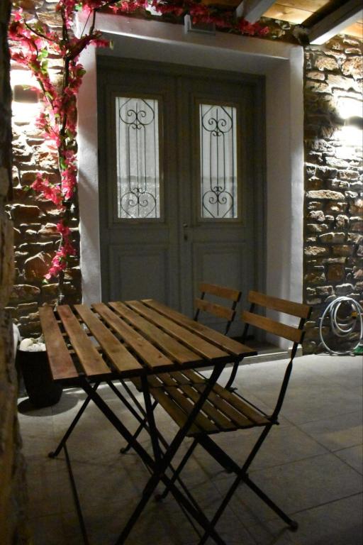 a wooden bench sitting in front of a door at Zk House Kythnos in Mérikhas