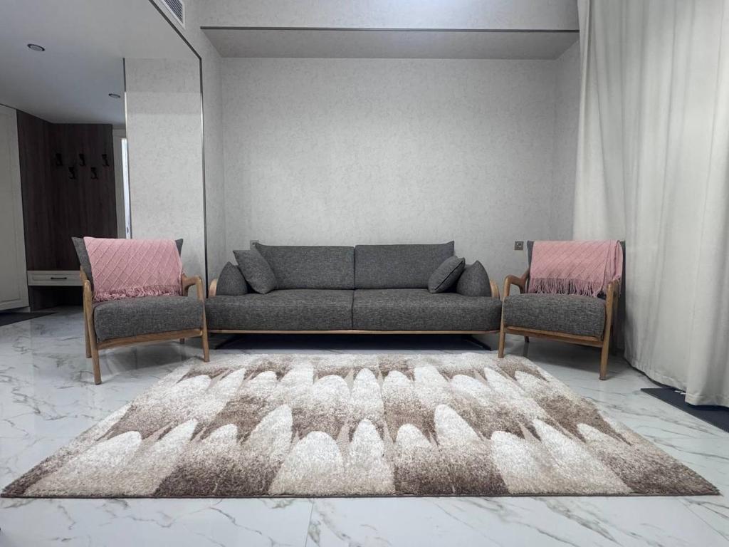 a living room with a couch and two chairs at Alvina Private Yard Apartment in Tsaghkadzor