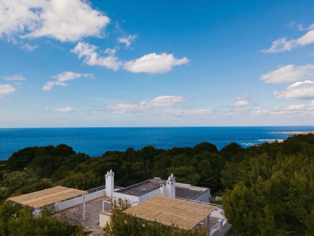a view of a building with the ocean in the background at Gariga Holidays Apartments in Nardò