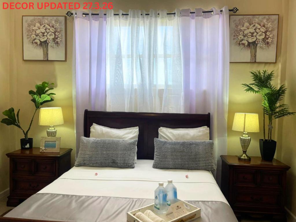 a bedroom with a large bed with two night stands at The Colosseum St Kitts in Basseterre