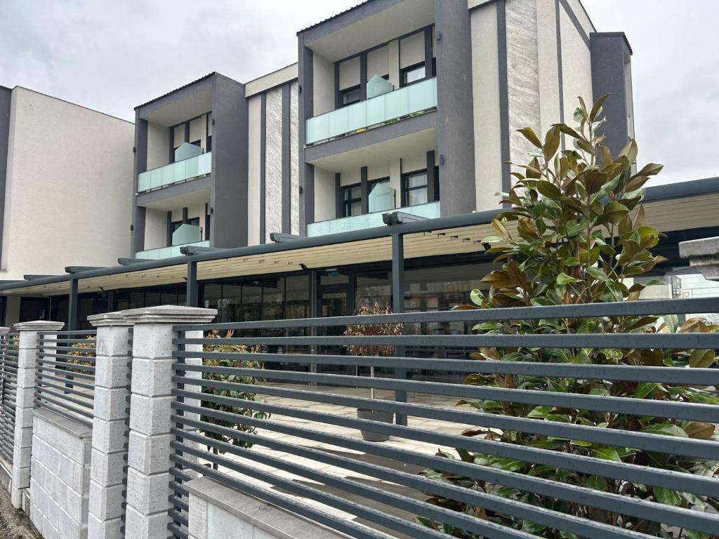 a building with a fence in front of it at Atri's Boutique in Aiud