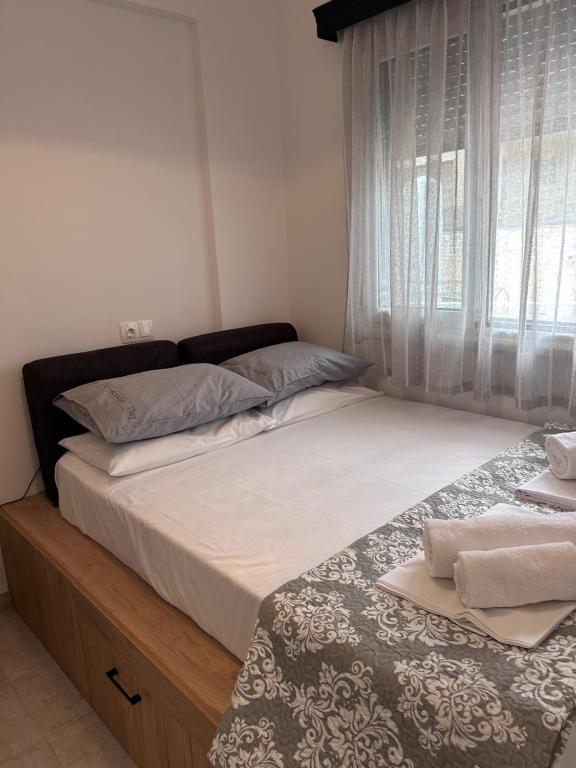 a bedroom with two beds and a window at Stegna Sunny-Beach in Archangelos