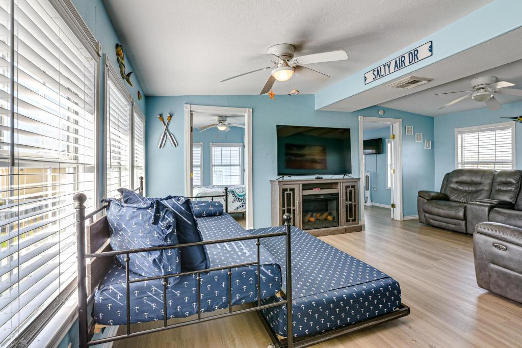a living room with a couch and a tv at 1 Block to Surfside Beach: Home w/ Deck! in Freeport