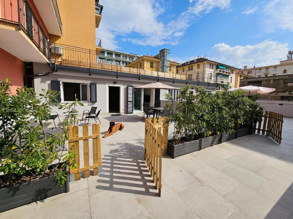 a patio with a wooden fence and a dog at Case di Daniela in Chiavari