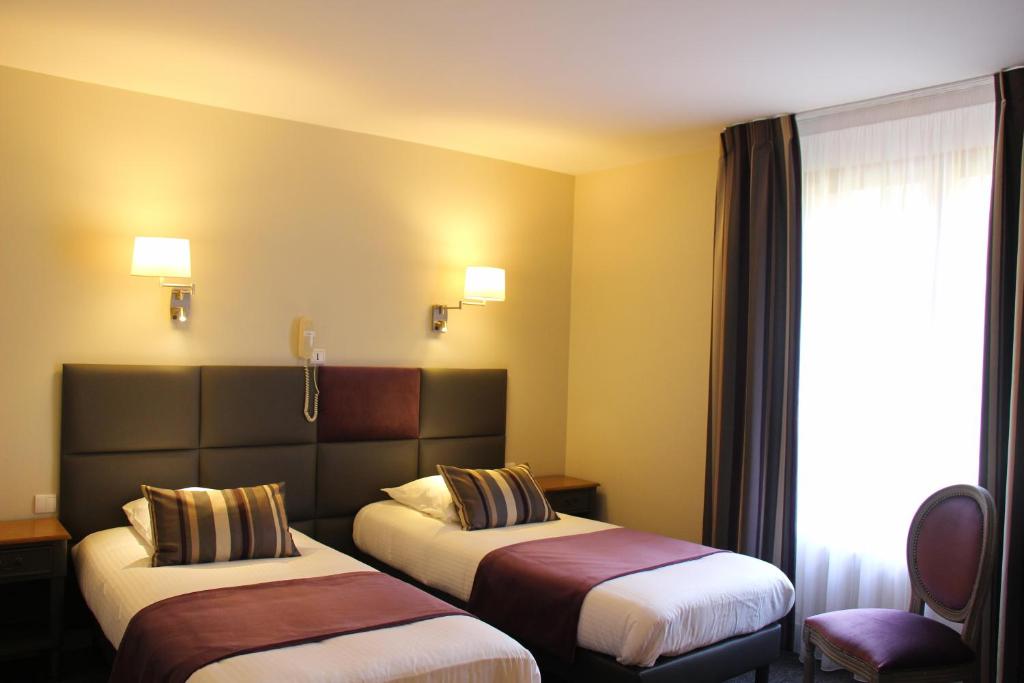 Postel nebo postele na pokoji v ubytování Hôtel Spa & Restaurant Ô Pervenches