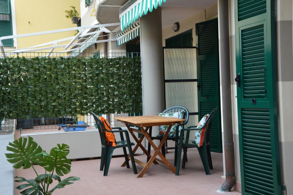 a wooden table and chairs on a patio at Mai senza Mare in Levanto