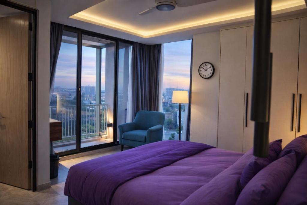 a bedroom with a large purple bed and a chair at Serene Comfort Suites in Rawalpindi