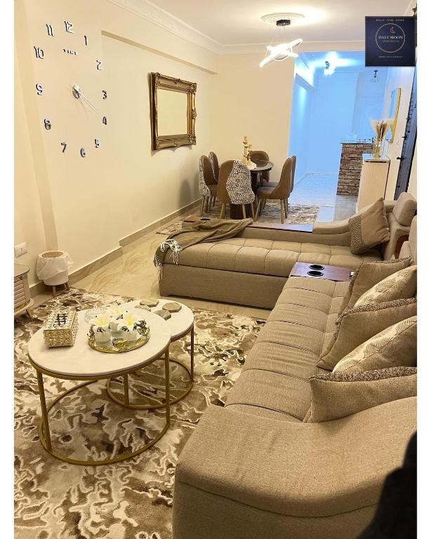 a living room with a couch and a table at Half Moon Apartaments in Alexandria