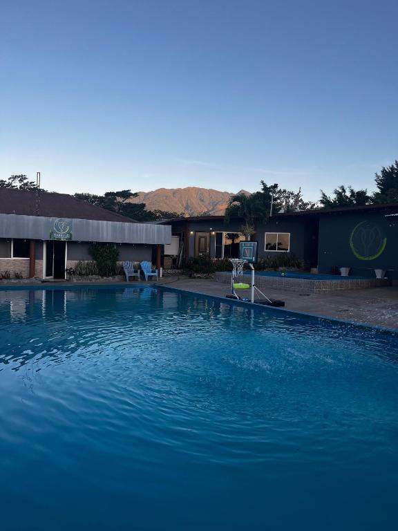 a large blue swimming pool in front of a building at Isabella Hostel and Pool in Alto Boquete