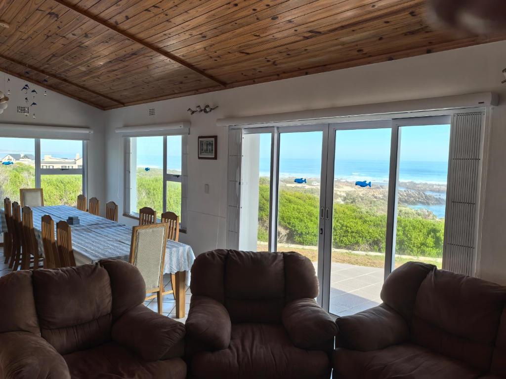 a living room with a couch and a table at The Lookout in Pearly Beach