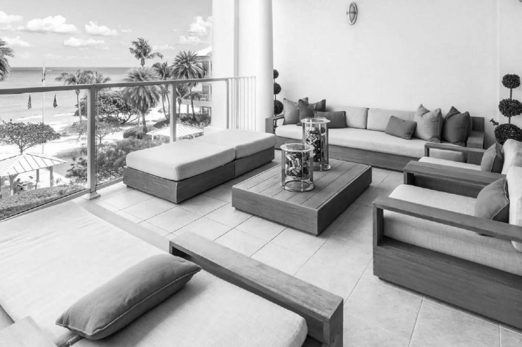 a living room with couches and a view of the beach at Superb 2 Bed Apartment in George Town