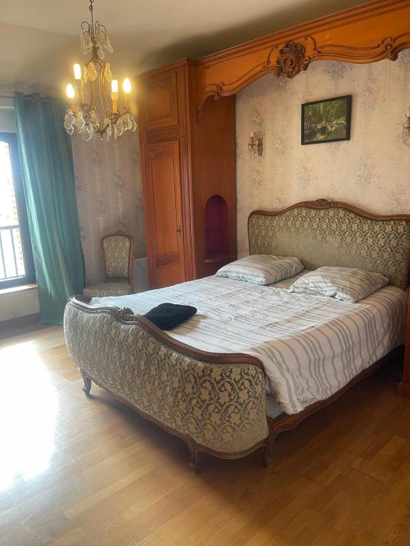a bedroom with a large bed with a large canopy at Canal du midi in Bazus