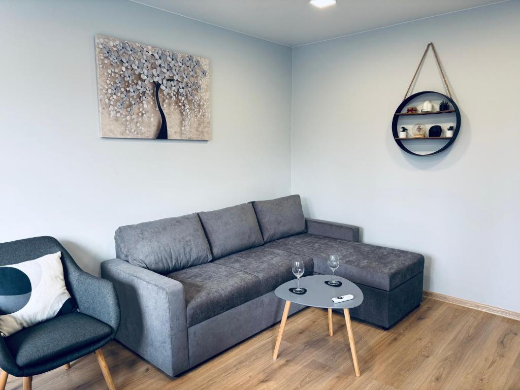 a living room with a couch and a table at Modern Apartment in Narva