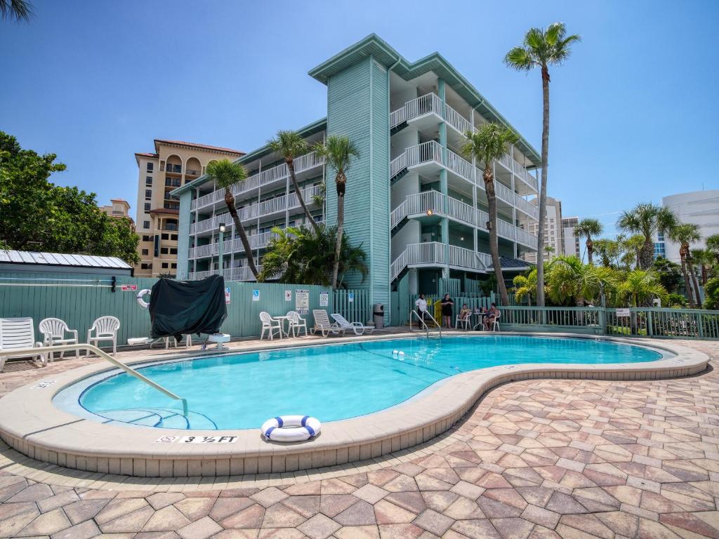 a swimming pool in front of a apartment building at Clearwater Beach Hotel in Clearwater Beach