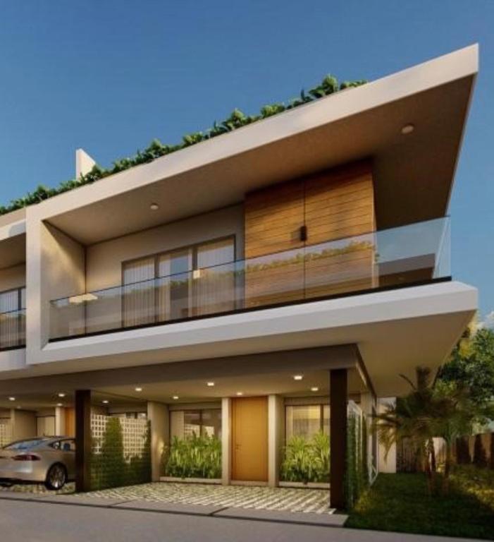 a building with a car parked in front of it at Villa Luminosa in Punta Cana