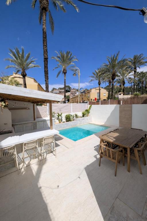 a patio with a table and chairs and a pool at Loft with Private Pool in Alzira in Alzira