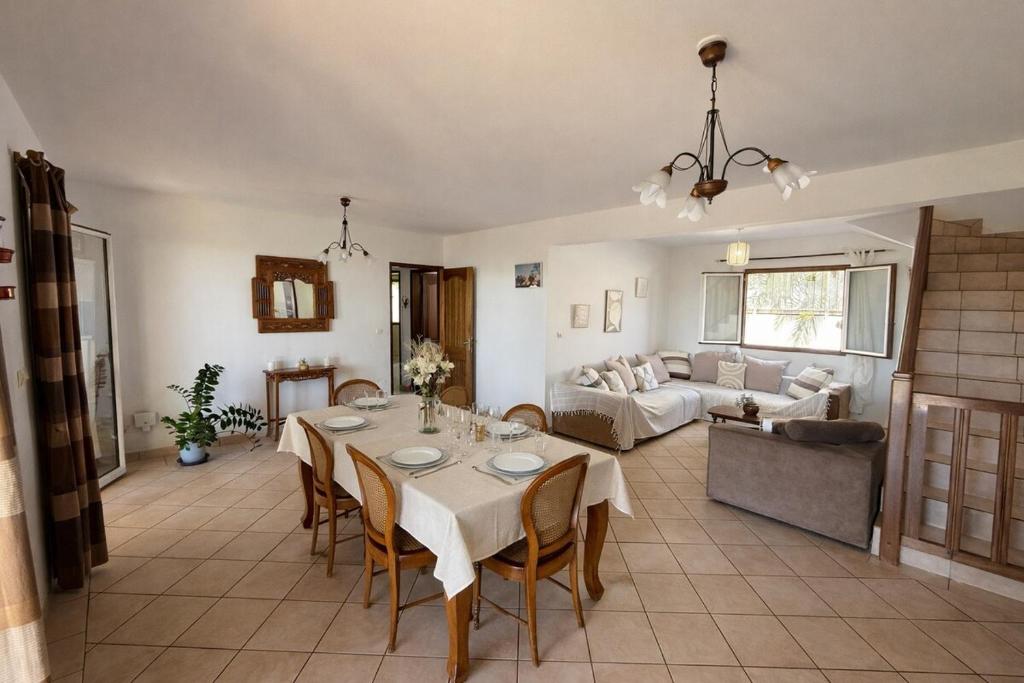 a living room with a table and a couch at La caza papangues in Sainte-Suzanne