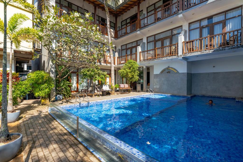 a large swimming pool in a building at Tartaruga Beach Unawatuna in Unawatuna