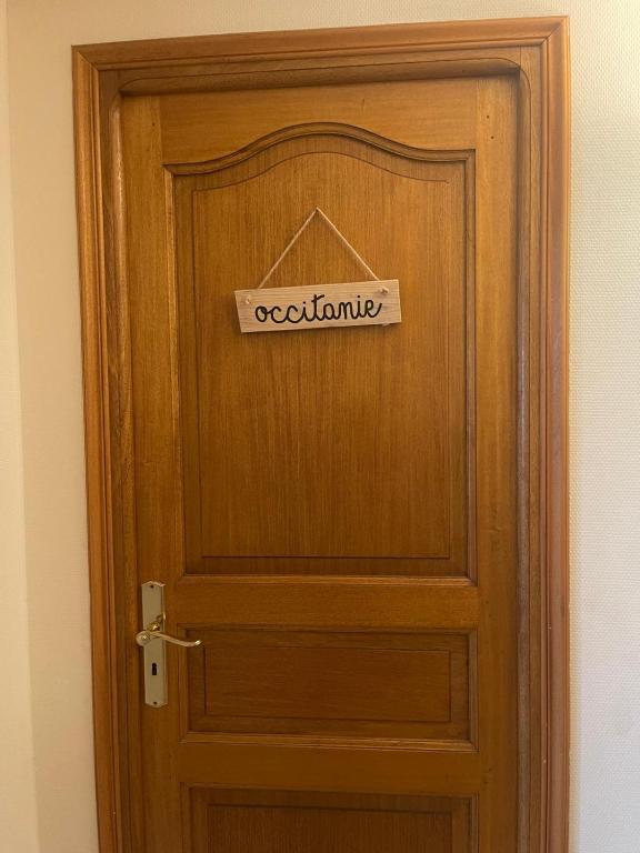 a wooden door with a sign on it at Occitanie in Bazus
