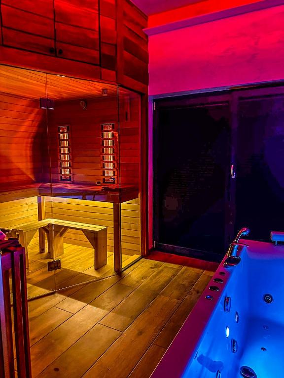 a room with a tub and a table in a room at Vila Bašić Vlašić JELEN Spa Apartman Sauna & Jacuzzi in Vlasic