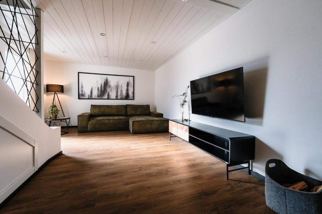 a living room with a couch and a flat screen tv at Seethal in Laufen