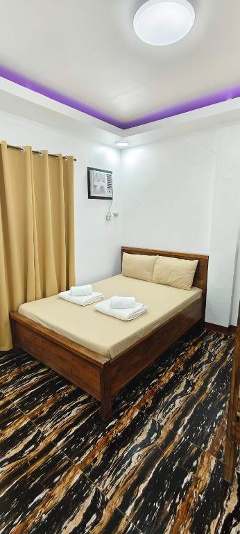 a bedroom with a bed with two towels on it at Amor apartment in Coron
