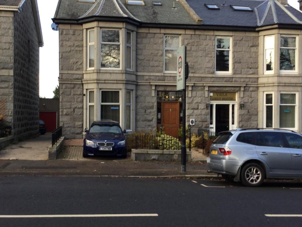 a car parked in front of a house at Belhaven Private Hotel in Aberdeen