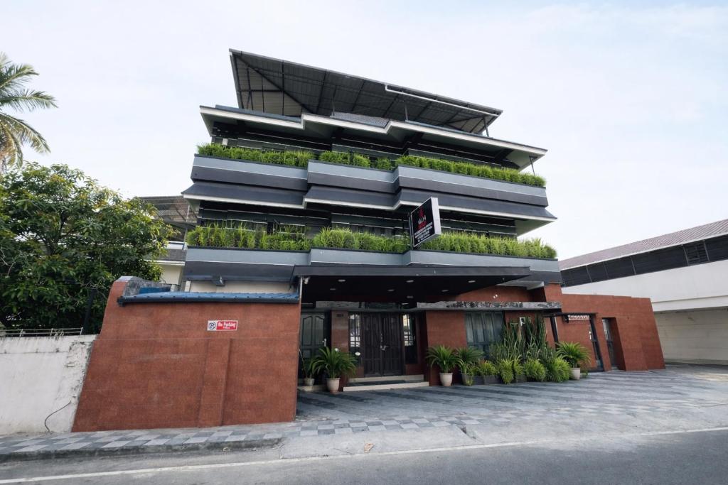 a building with plants on the side of it at W H Nest Hostel in Cochin