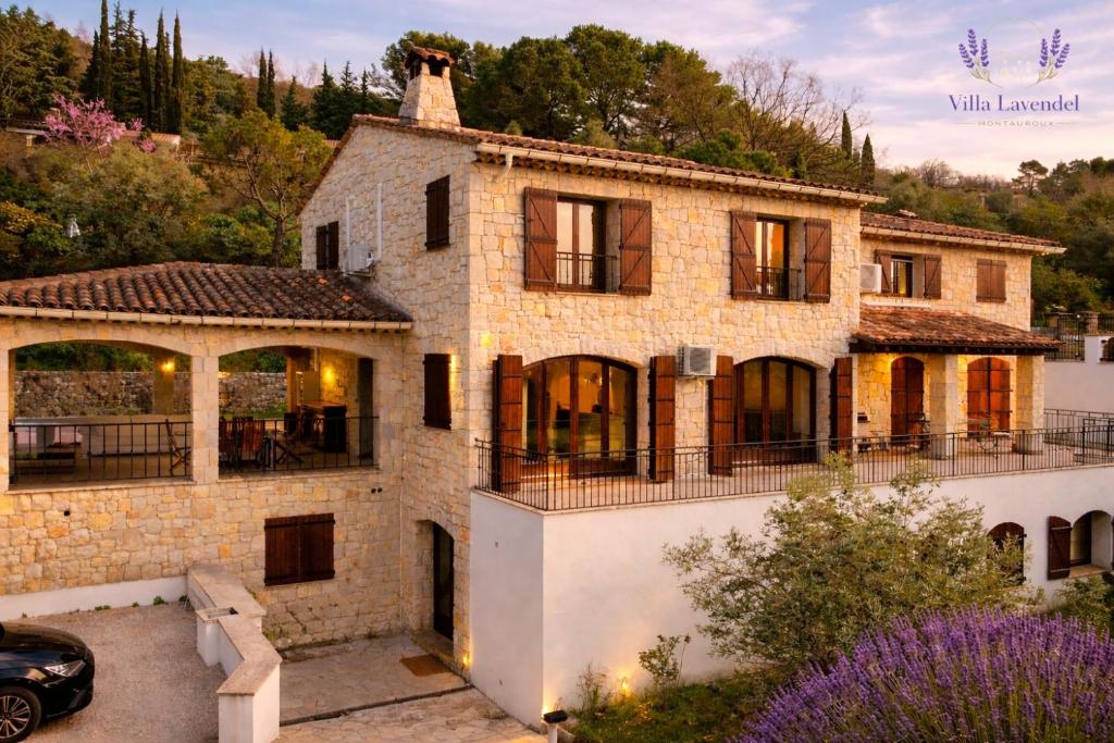 a stone house with a car parked in front of it at Villa Lavendel in Montauroux