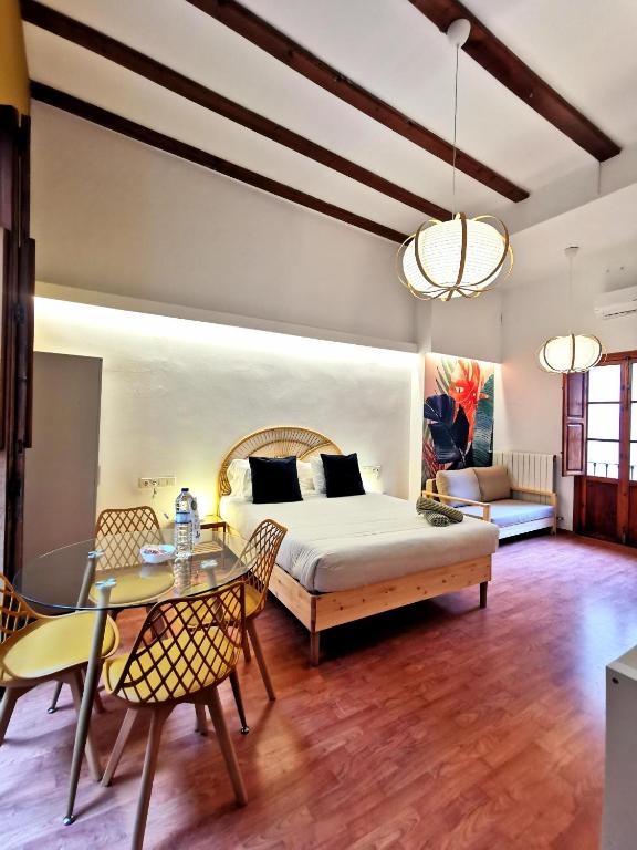 a bedroom with a bed and a table and chairs at Bellver bedrooms in Xàtiva