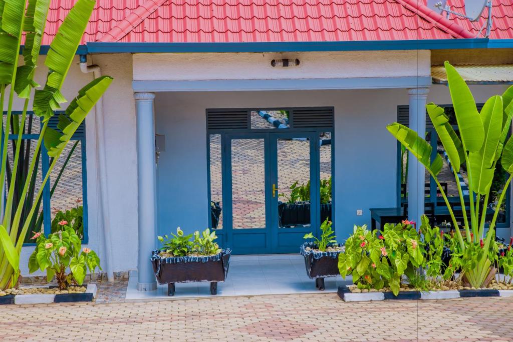 a blue front door of a house with plants at Ritha Motel Apartment in Kigali