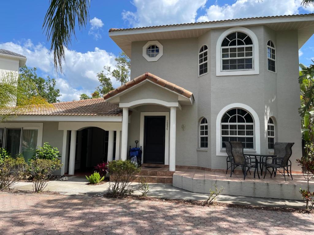 a white house with a porch and patio at Beautiful property on Siesta Key in Siesta Key