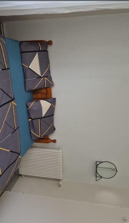 a room with three ties on a wall at Mais pour ce jour in Brest