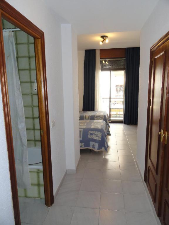 Postel nebo postele na pokoji v ubytování Hotel El Coloso