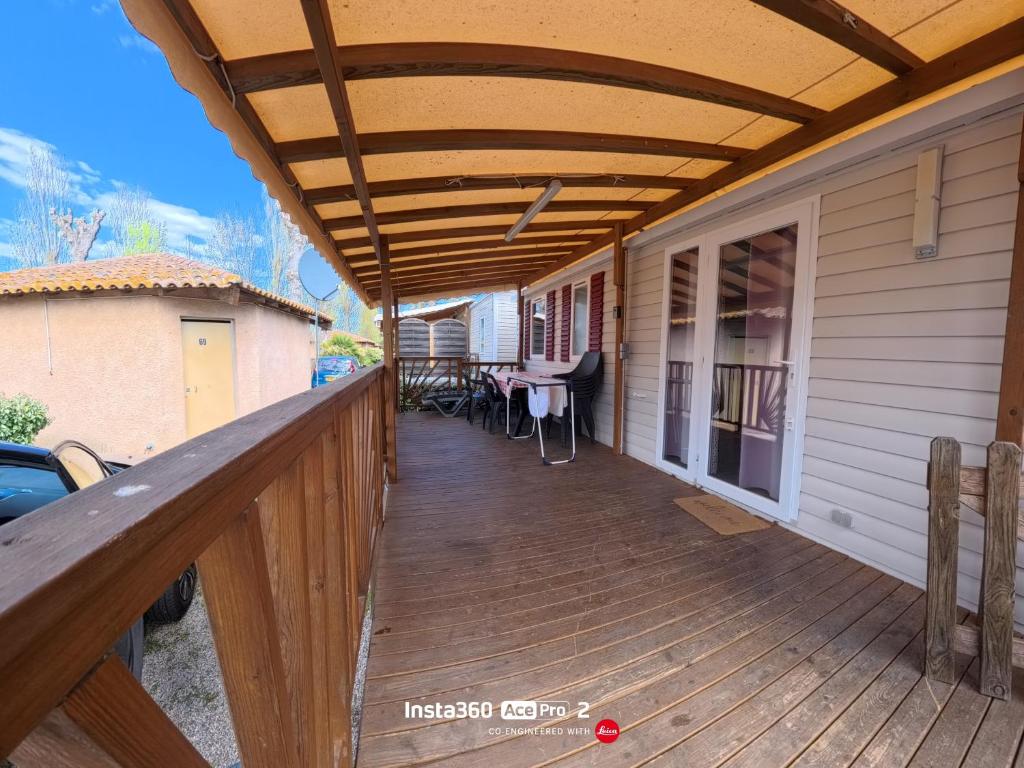 a wooden deck with awning on a house at La Carabasse / Mazet 69 in Vias