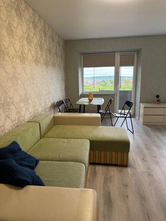 a living room with a couch and a table at Vokzalna in Mukacheve