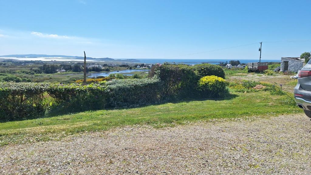 a car parked on the side of a gravel road at Gweedore Seaview Cottage in Bun na Leaca